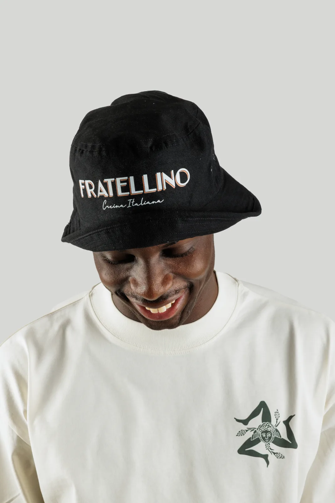 Cappello bucket Fratellino nero ricamato, indossato di fronte