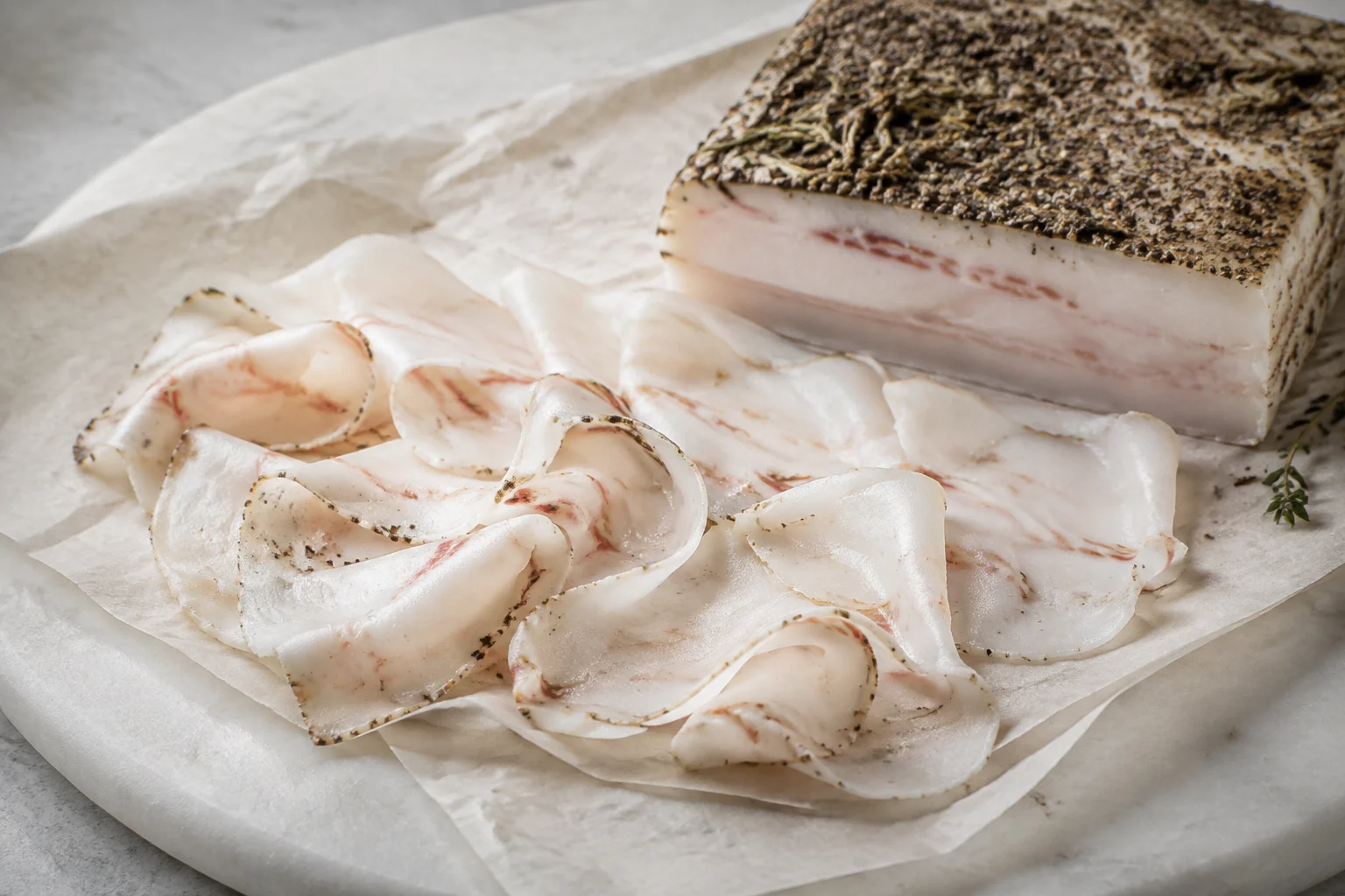 Tranches fines de Lardo di Colonnata sur pain de campagne